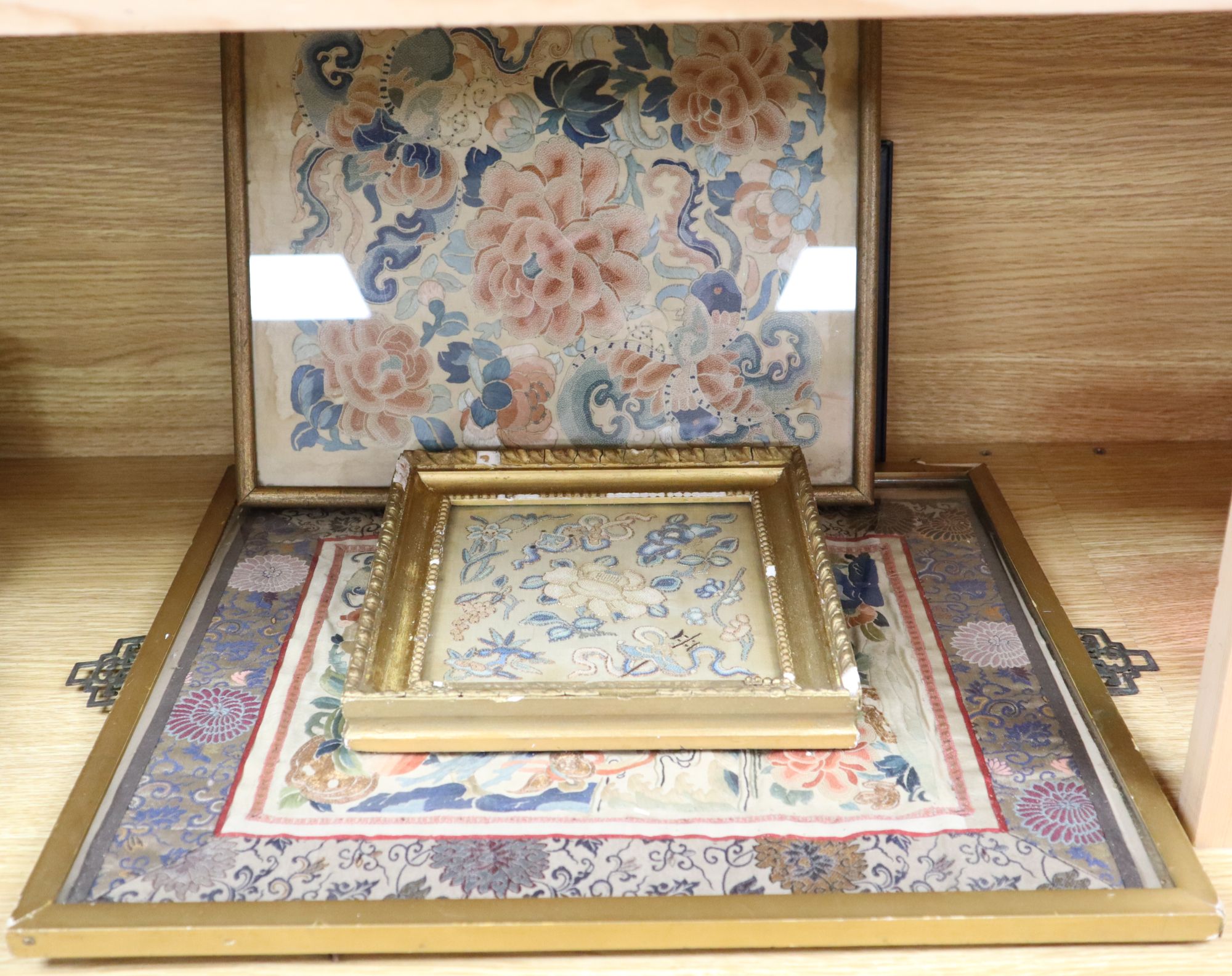 Three Chinese embroidered silk floral panels and a similar woven with objects, 19th century